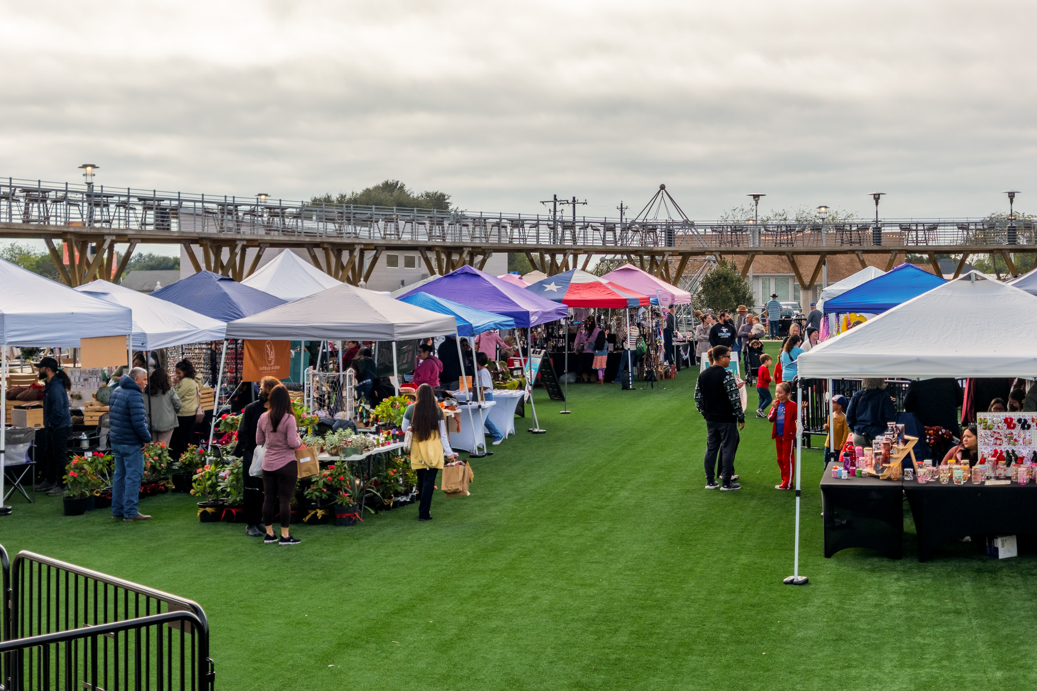 Shoppers browsing vendor tents at the Portland Farmers Market