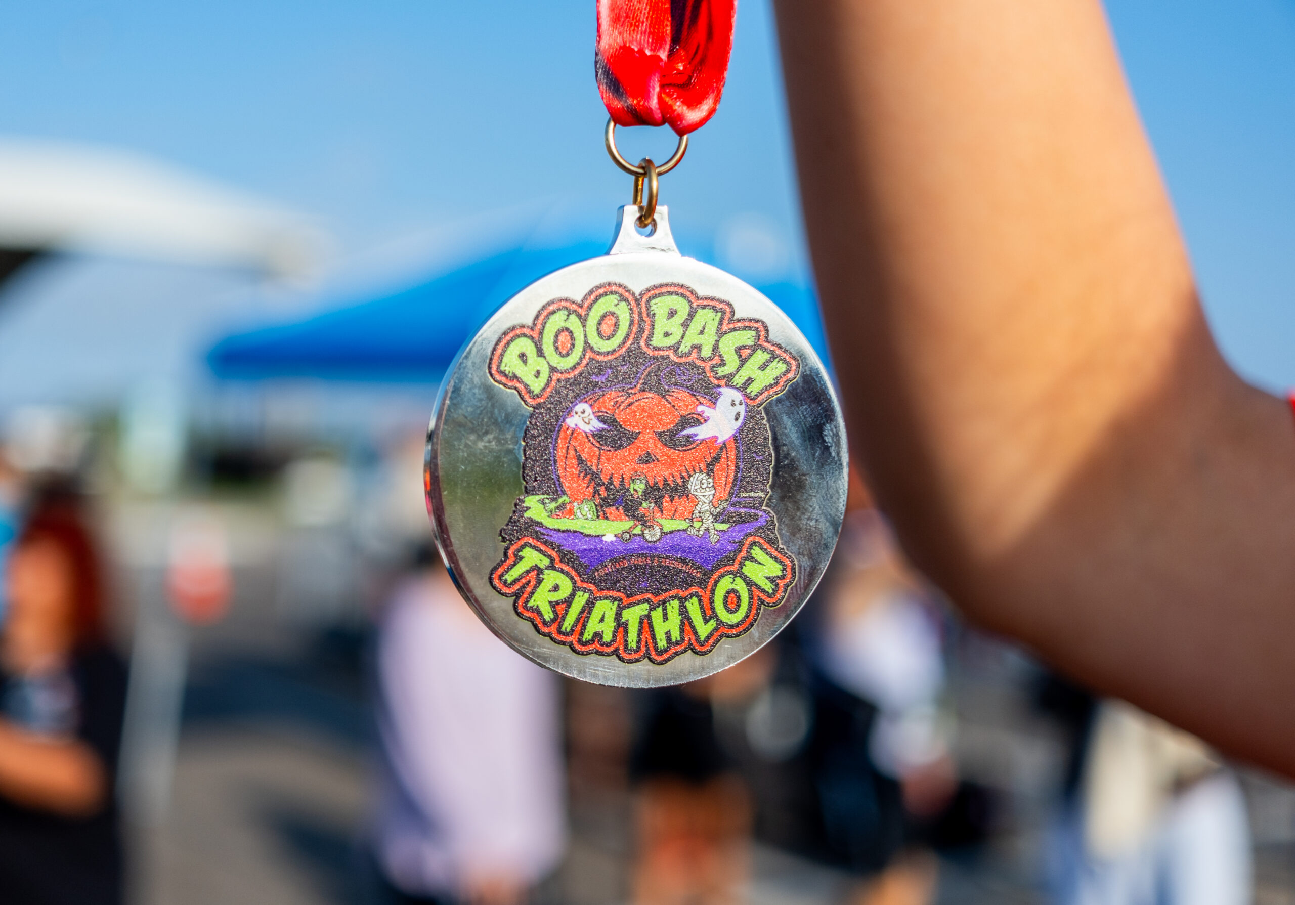 A Boo Bash Triathlon finisher medal with a jack-o&rsquo;-lantern design