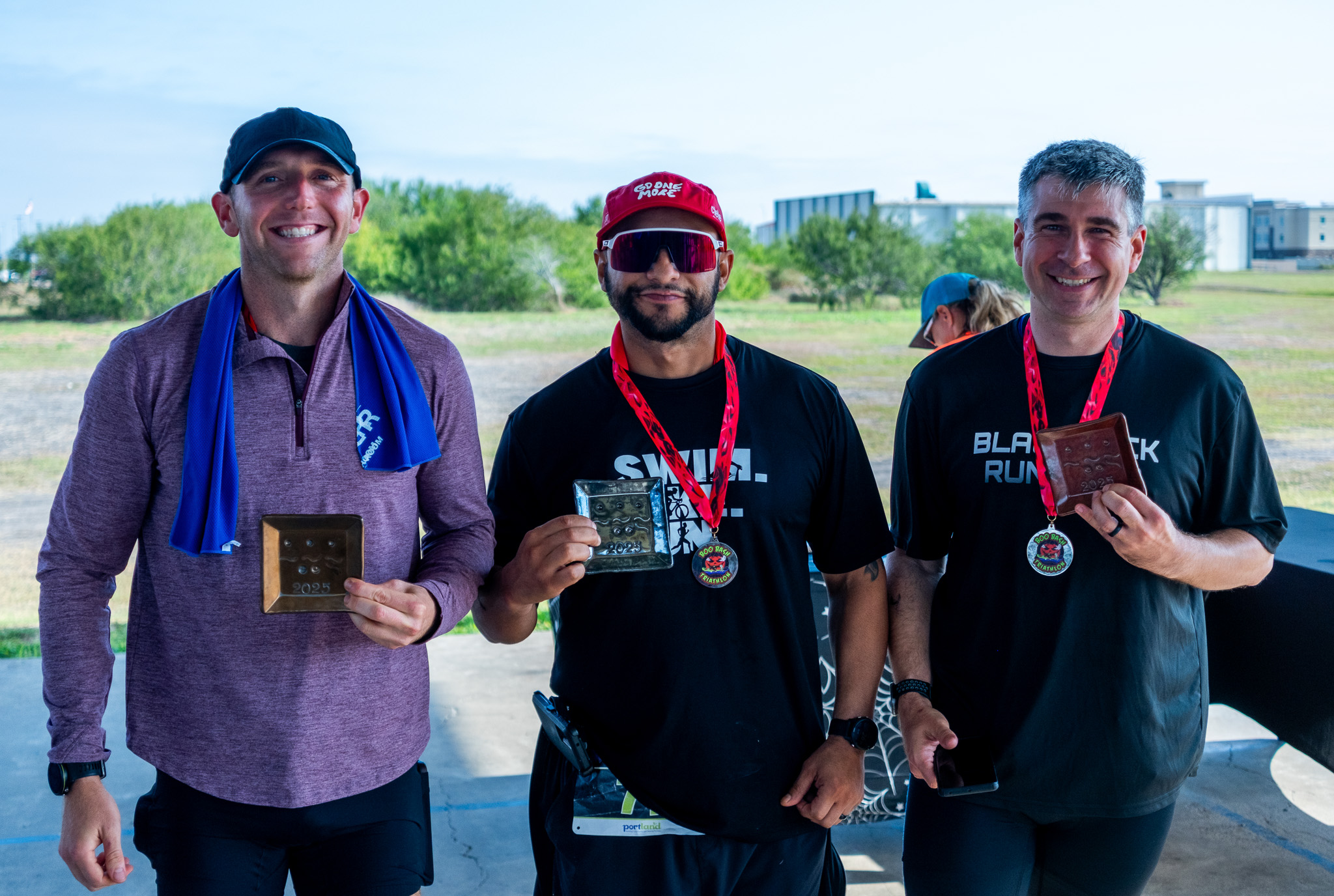 Three age group winners posing with their awards