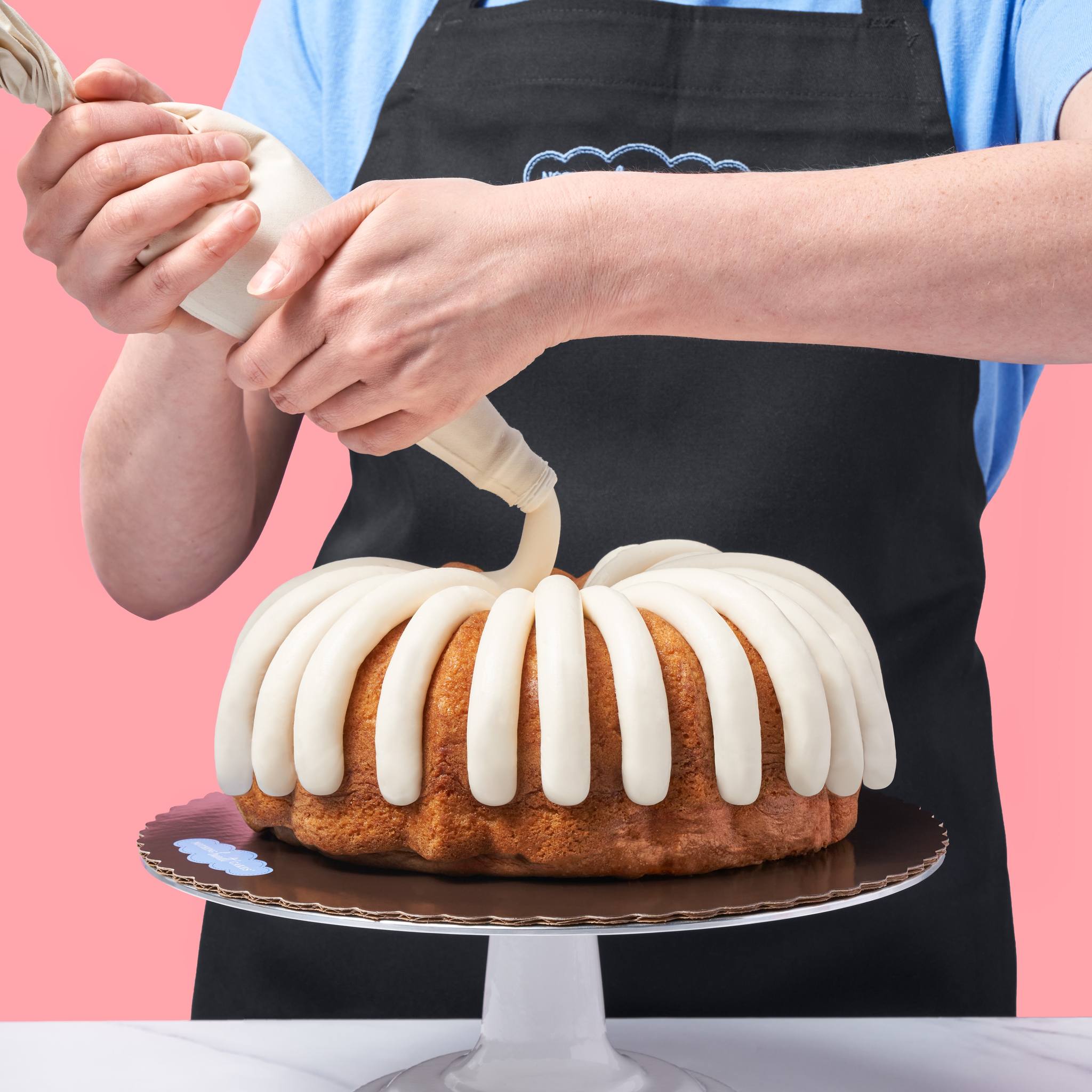 Picture of a man icing a cake from Nothing Bundt Cakes