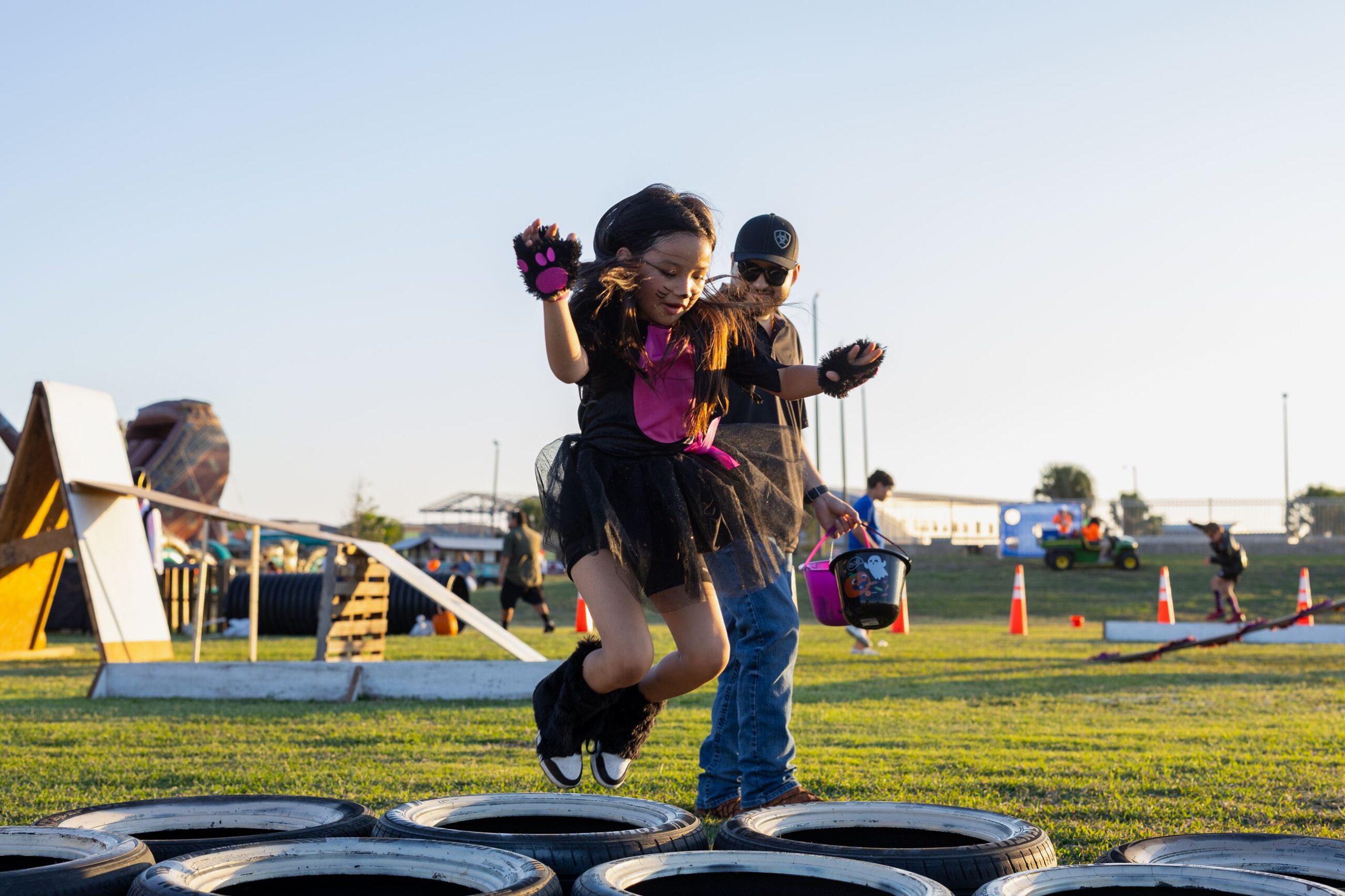 Kids jumping through the tire obstacle course