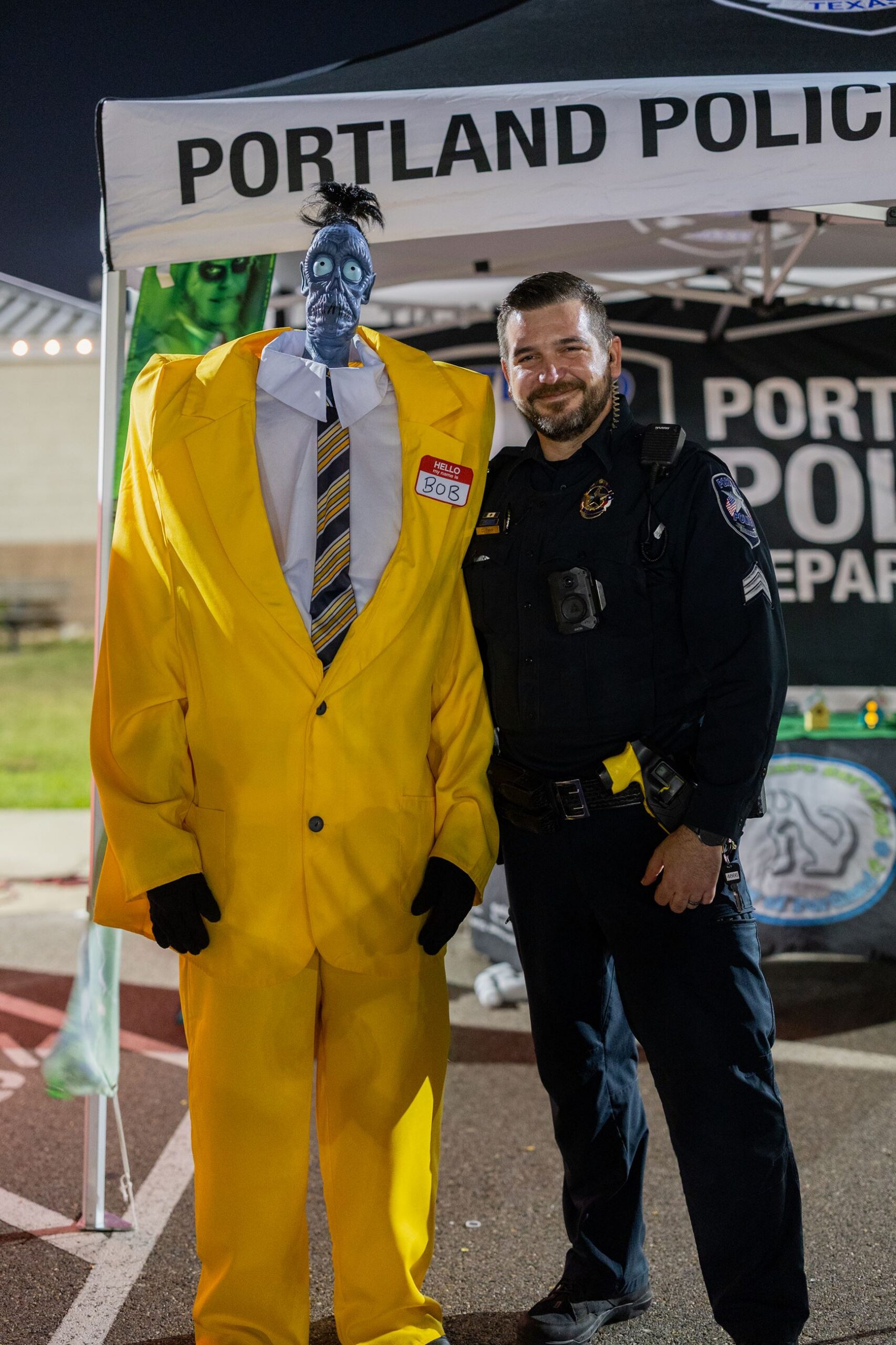 A Portland Police officer and a costumed guest at the Trick-or-Treat Trail
