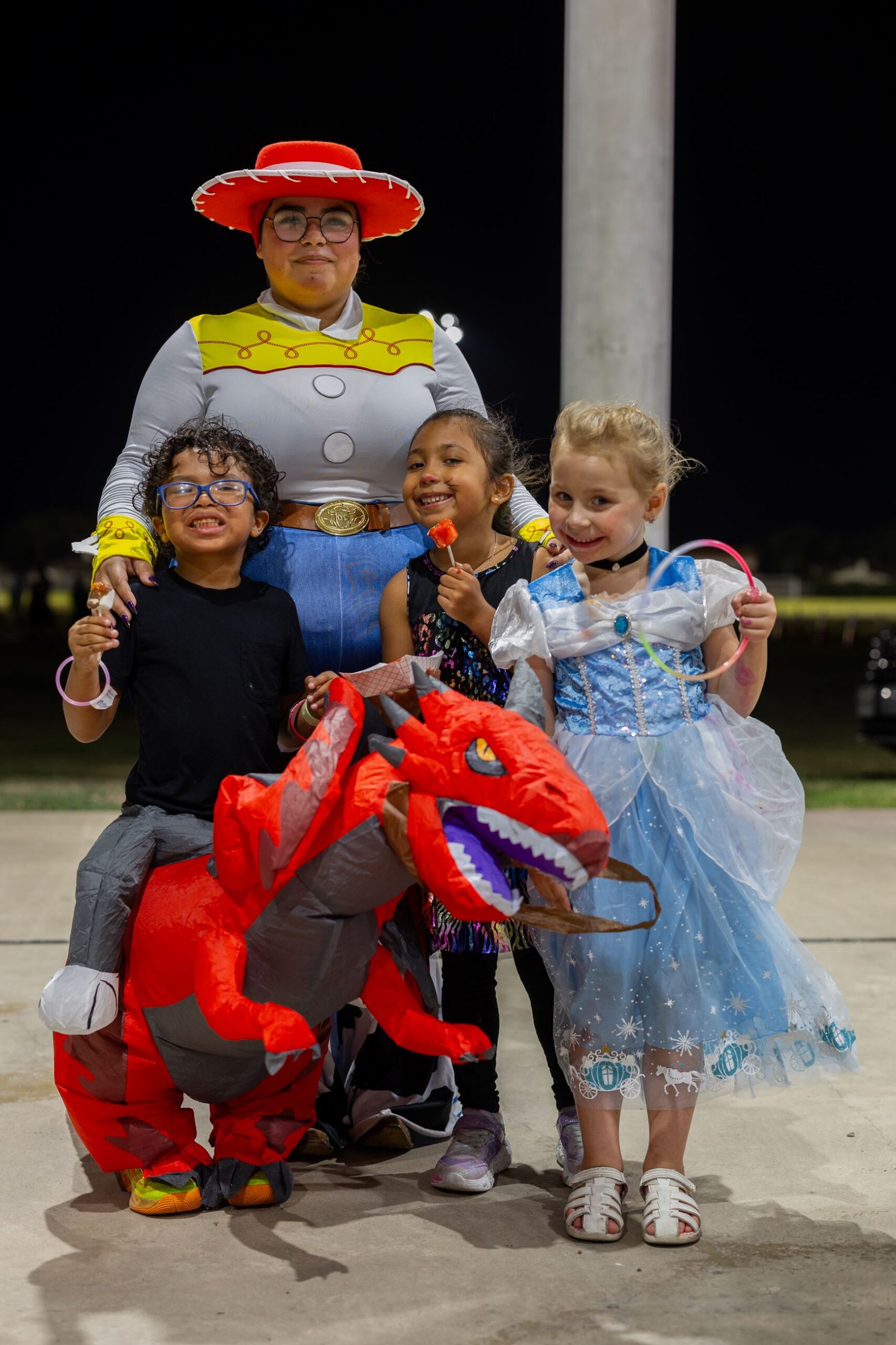 Kids in costume posing with a cowgirl character