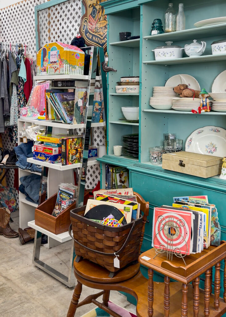 Shelves of secondhand treasures inside My Mom Had That! thrift shop