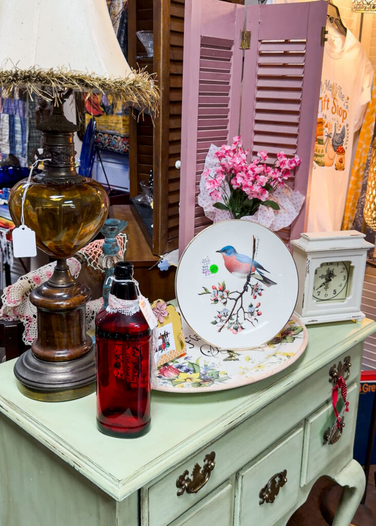Vintage home decor merchandised on shelves at The Vintage Butterfly